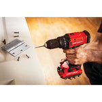Cordless half inch drill and driver kit 1 battery being used for drilling in wooden door.
