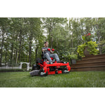 CRAFTSMAN Gas Zero-Turn cutting grass around deck steps with white archway in background