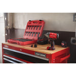 Half inch drive brushless cordless impact wrench placed of craftsman tool table next to tools.