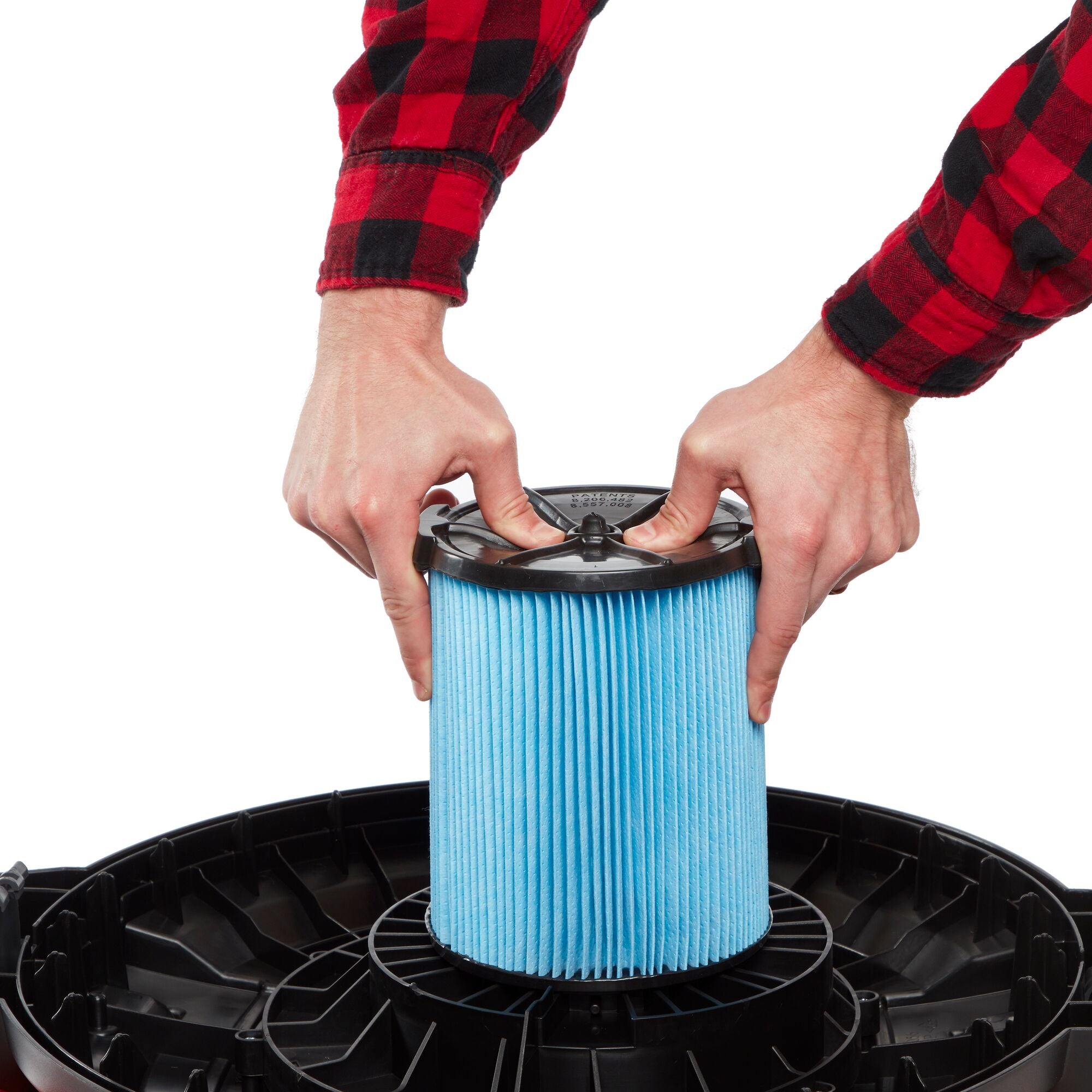 Person installing CRAFTSMAN Fine Dust Replacement Filter onto wet/dry shop vac powerhead