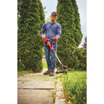 20 volt weedwacker 13 inch cordless string trimmer and edger with automatic feed kit being used by a person to cut grass outdoors.