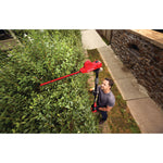 20 volt 18 inch cordless pole hedge trimmer kit being used by a person to trim plants.