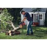 Cordless 10 inch chainsaw kit 2 amp hour being used for cutting tree trunk.