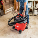 DIYer standing in workshop illustrating 180 degree DUAL-FLEX capability of locking shop vacuum hose