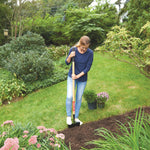 Wood handle turf edger being used by a person.