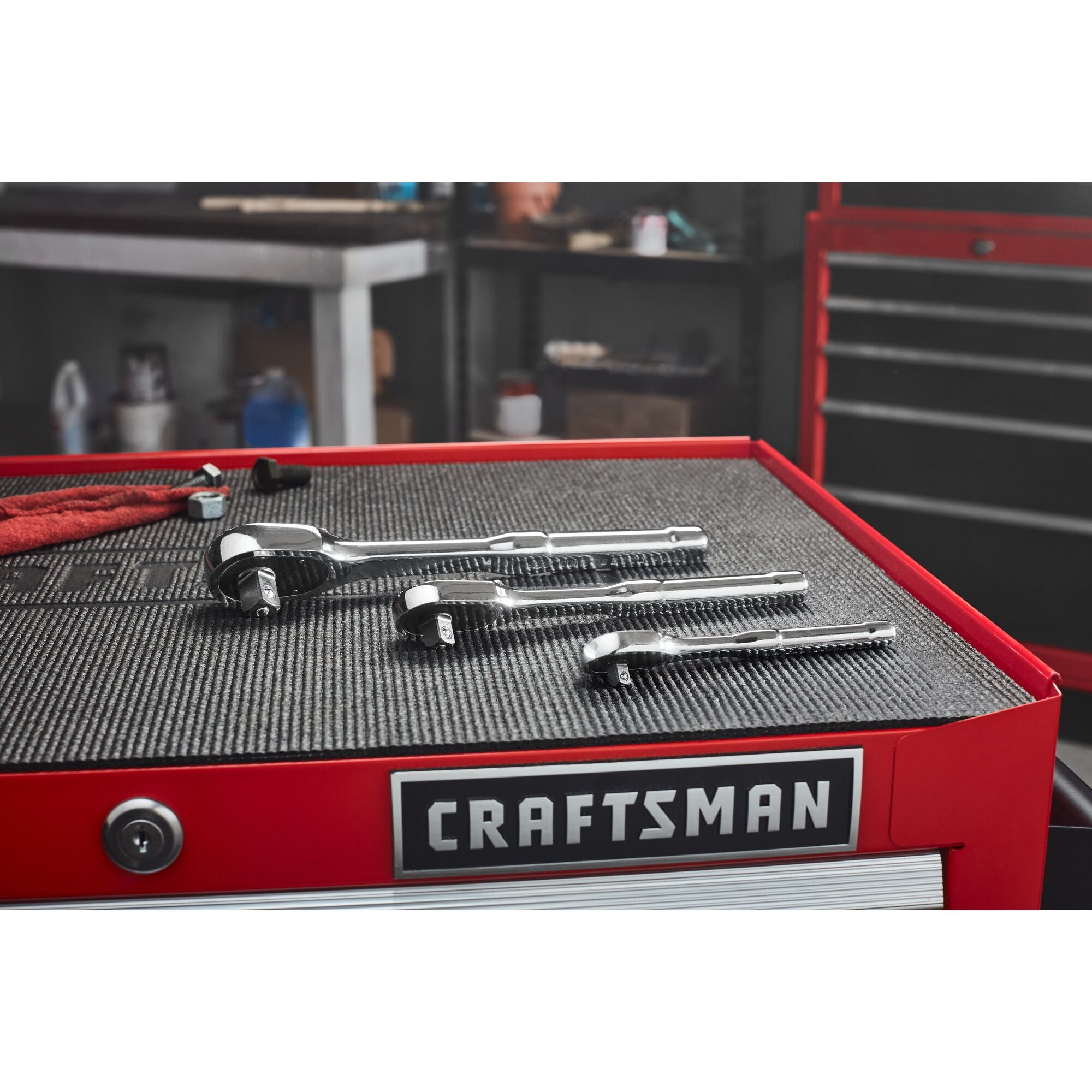 Group shot of 3 CRAFTSMAN Low Profile ratchets on a metal workstation