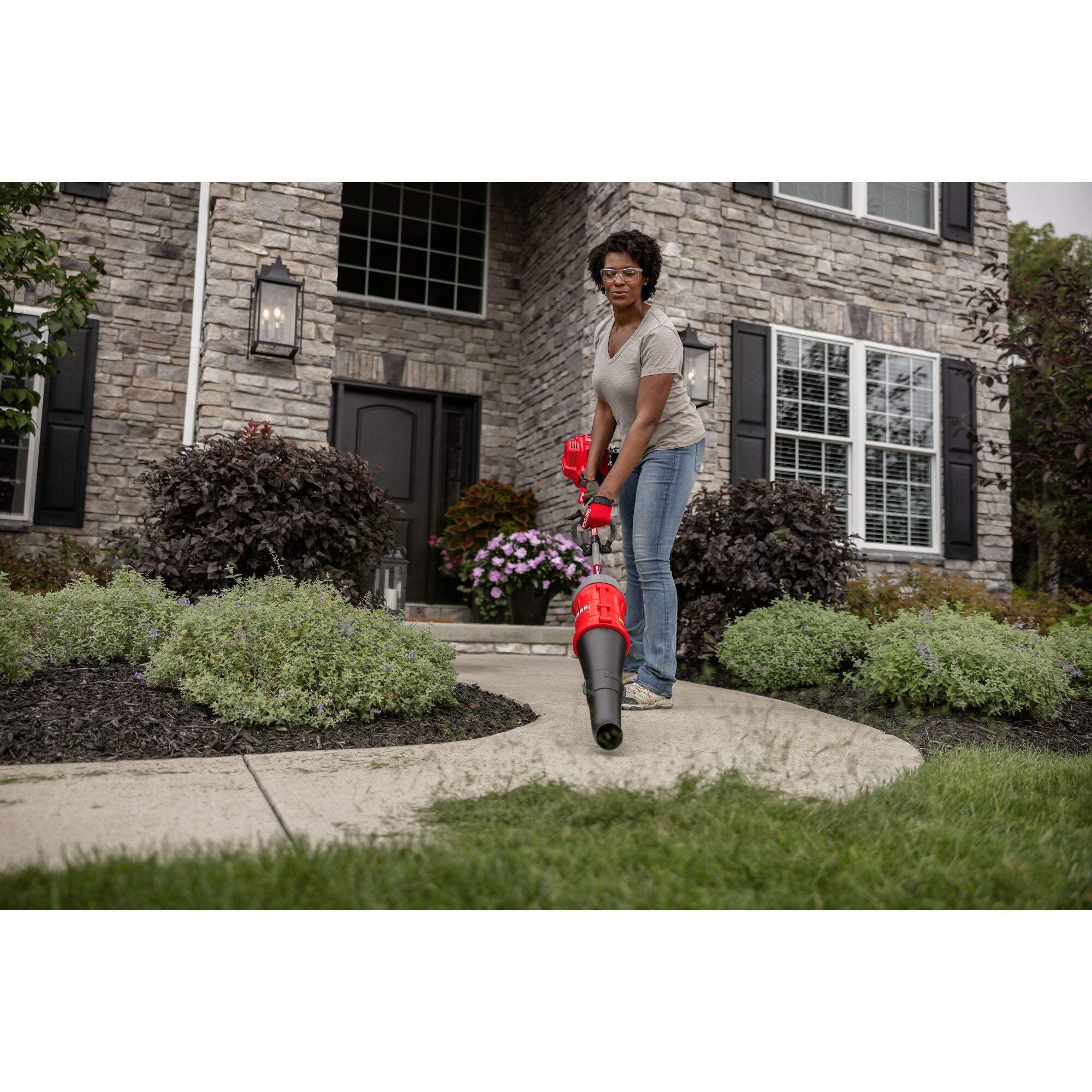 CRAFTSMAN Multi-Tool Attachment Blower blowing sidewalk off in front of house