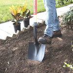 Wood handle digging shovel being used.