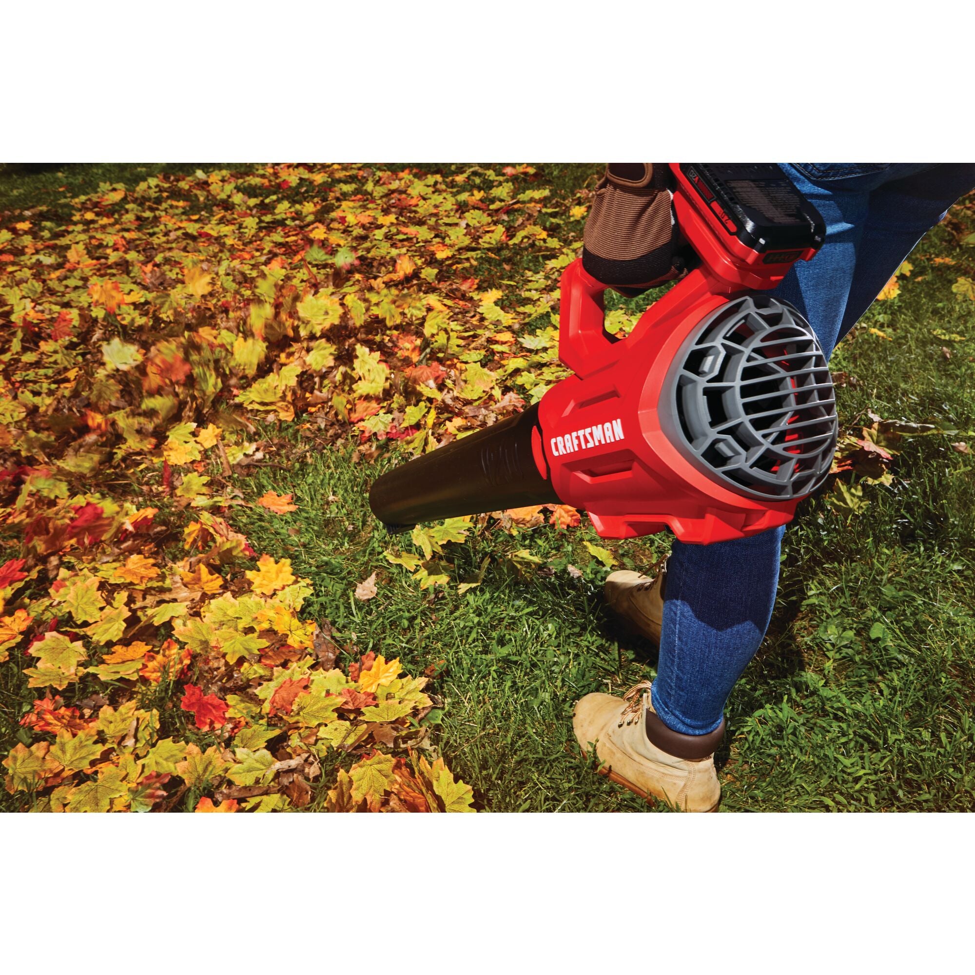 2 x 20 volt 20 inch brushless cordless push mower being used for mowing grass by person.