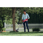 20 volt cordless 10 inch weedwacker string trimmer and edger being used by a person outdoors.