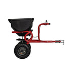 85 pounds tow broadcast spreader placed in the lawn attached to mower.
