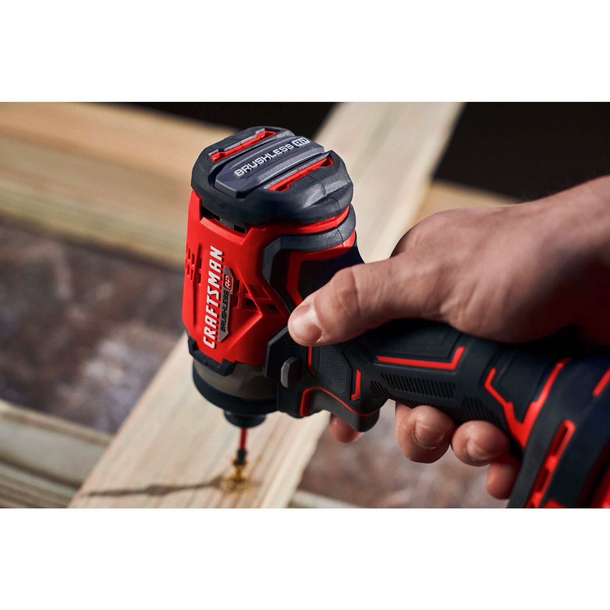 Man in dark shirt drills into wood with CRAFTSMAN V20 drill.