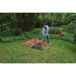 Wood handle 30 inch leaf rake being used by a person.