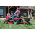 110 pounds tow broadcast spreader being used in the lawn.