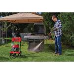 3100 MAX Pounds per Square Inch or 2 and seven tenths MAX Gallons Per Minute Pressure Washer being used by person to wash Bar B Que grills placed outdoors in lawn.