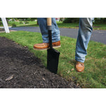 Wood handle border spade being used to dig up dirt.