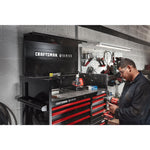 Mechanic working in automotive shop filled with various CRAFTSMAN V-Series™ storage and tools