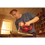 20 volt cordless jig saw kit being used by a person to cut wood at a workshop.