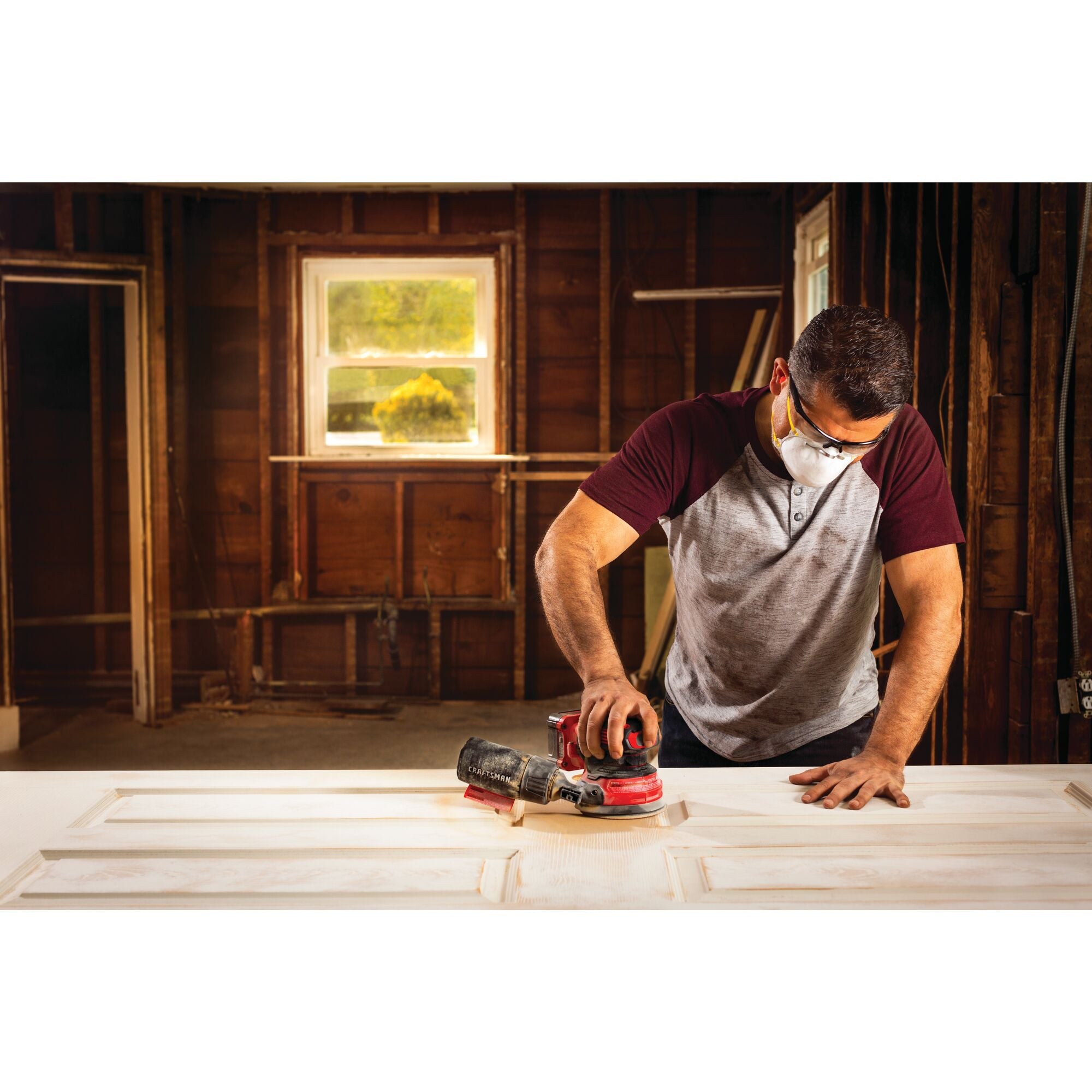 20 volt cordless random orbit sander being used by a person.