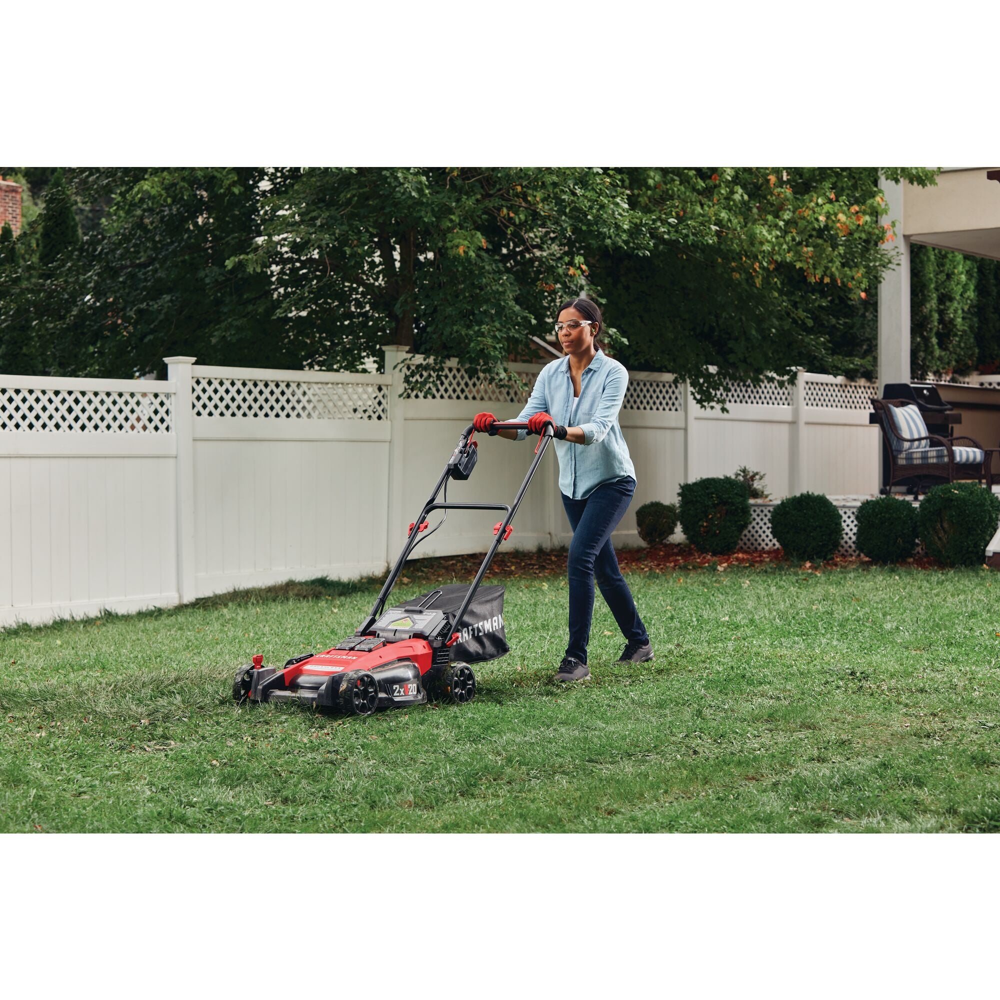 2 x 20 volt 20 inch brushless cordless push mower being used for mowing grass.