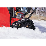 CRAFTSMAN 208CC Electric Start Track Drive Snow Blower zoomed into the wheel in the snow