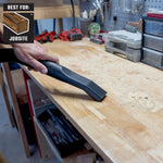 Person cleaning up sawdust on workbench in garage with 4 gallon shop vacuum and car nozzle
