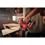 20 volt cordless jig saw kit being used by a person to cut a wood.