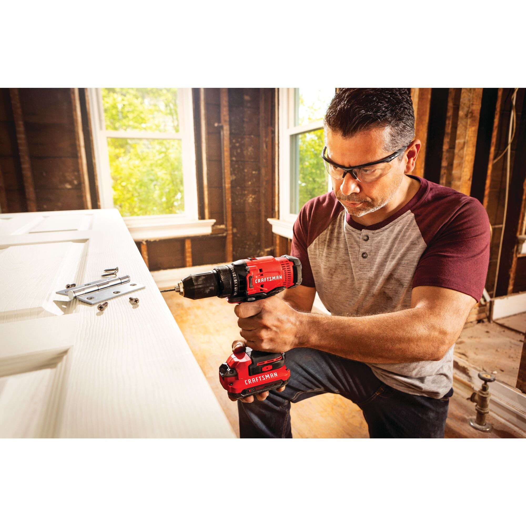 Cordless half inch drill and driver kit 1 battery being used for drilling in wooden door.