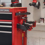 2 CRAFTMAN® Drills stored in holder on side of metal storage cabinet