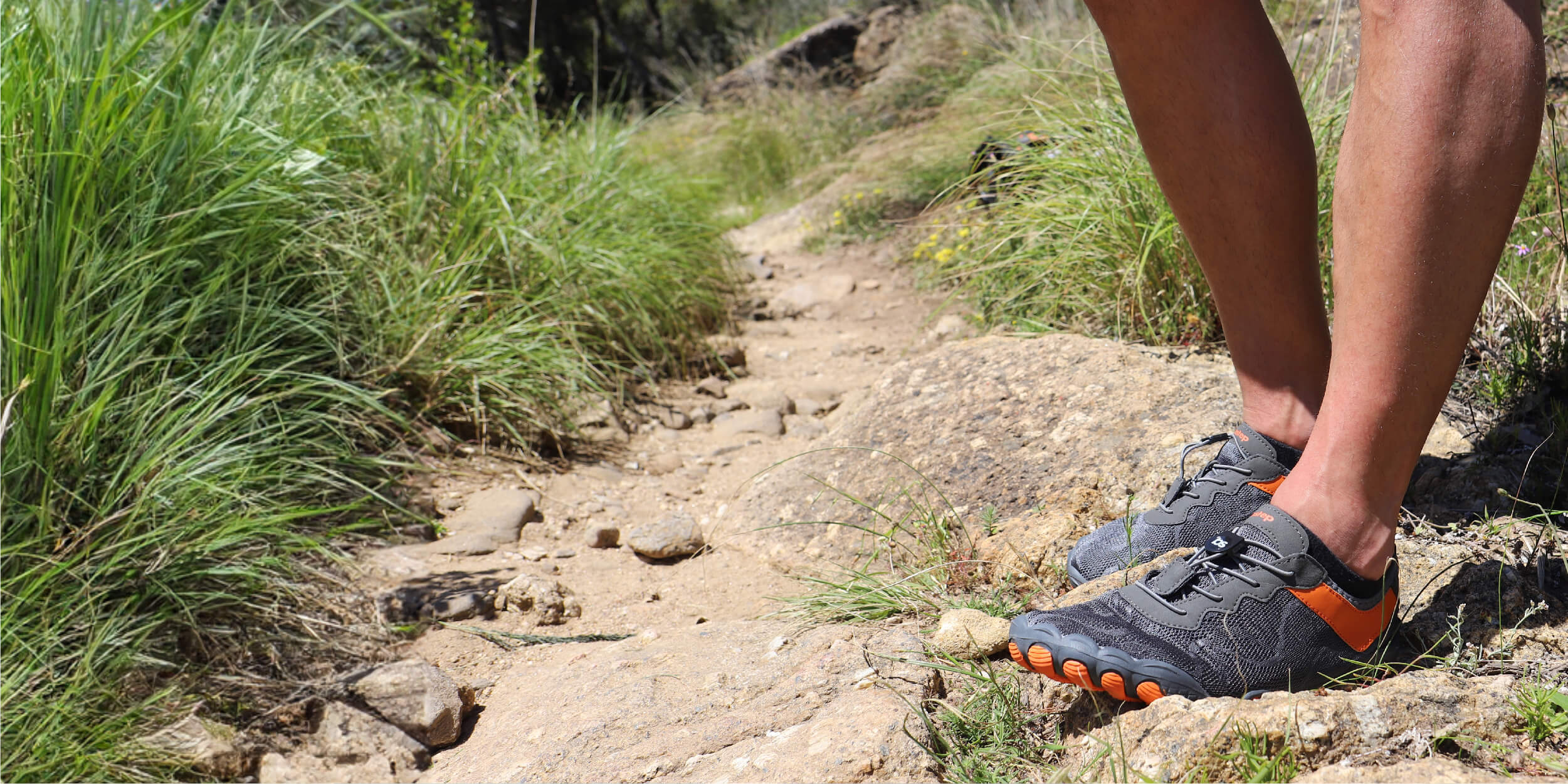 man wearing Barestep Active 2.0 barefoot shoe in nature, showcasing it's versatile design.