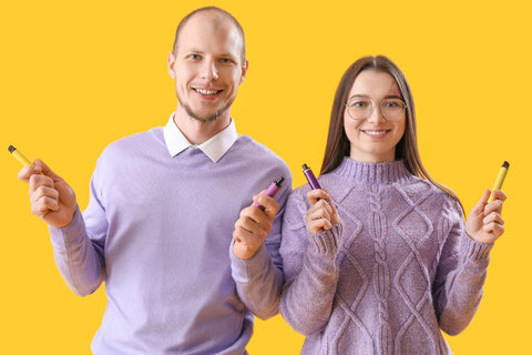 A guy and a girl holding disposable vape in their hands after drying