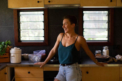 Jadine Hanys nutritionist in her beautiful, sustainable kitchen ready to prepare a nourishing meal for her clients seeking dietary and overall health improvement.