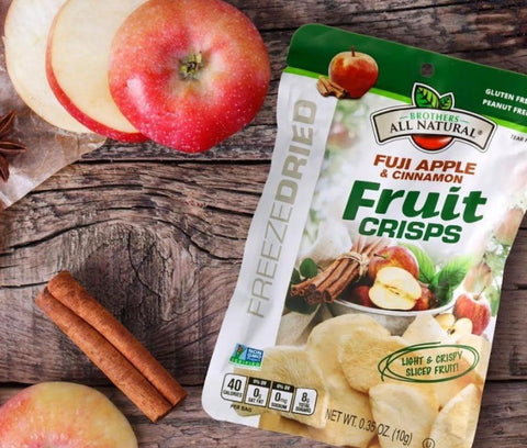 Brothers All Natural Freeze Dried Fruit Crisps on a table with apple slices, corporate gift boxes, office gift boxes, corporate snack box, office snack box, pantry snack, healthy snacks, gift box, snack box, delivery, pantry snacks, singapore, office gifting, office snacks