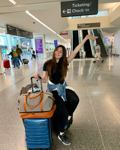 girl with suitcases in airport moving abroad
