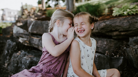 2 Girls Giggling Wearing Organic Clothing