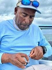 Dennis Tying a fly in the middle of the bay