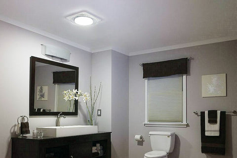 Bathroom exhaust fan with light installed in ceiling