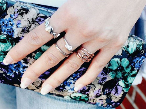 woman wearing multiple fashion rings