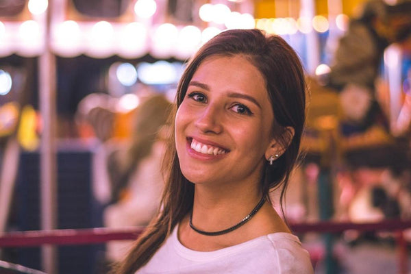 smiling woman wearing stud earrings