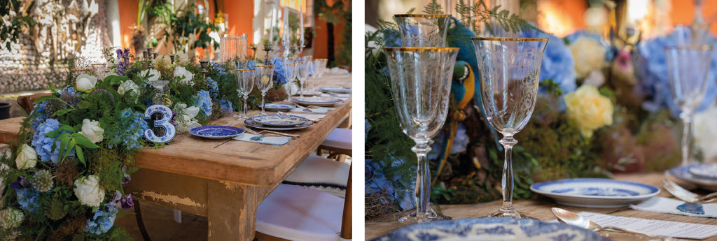 wooden table with glass goblets, blue plates and blue flowers