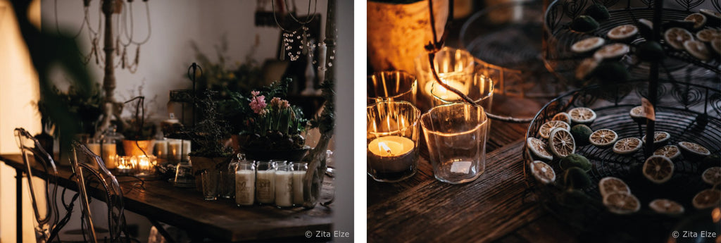 dark mood photo of candles and dried lime on a wooden table