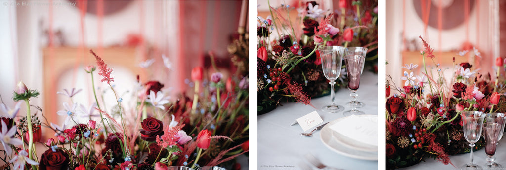 Red and burgundy flowers decorating a dining set