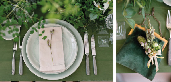 elegant plate and cutlery set up with green table cloth and flowers