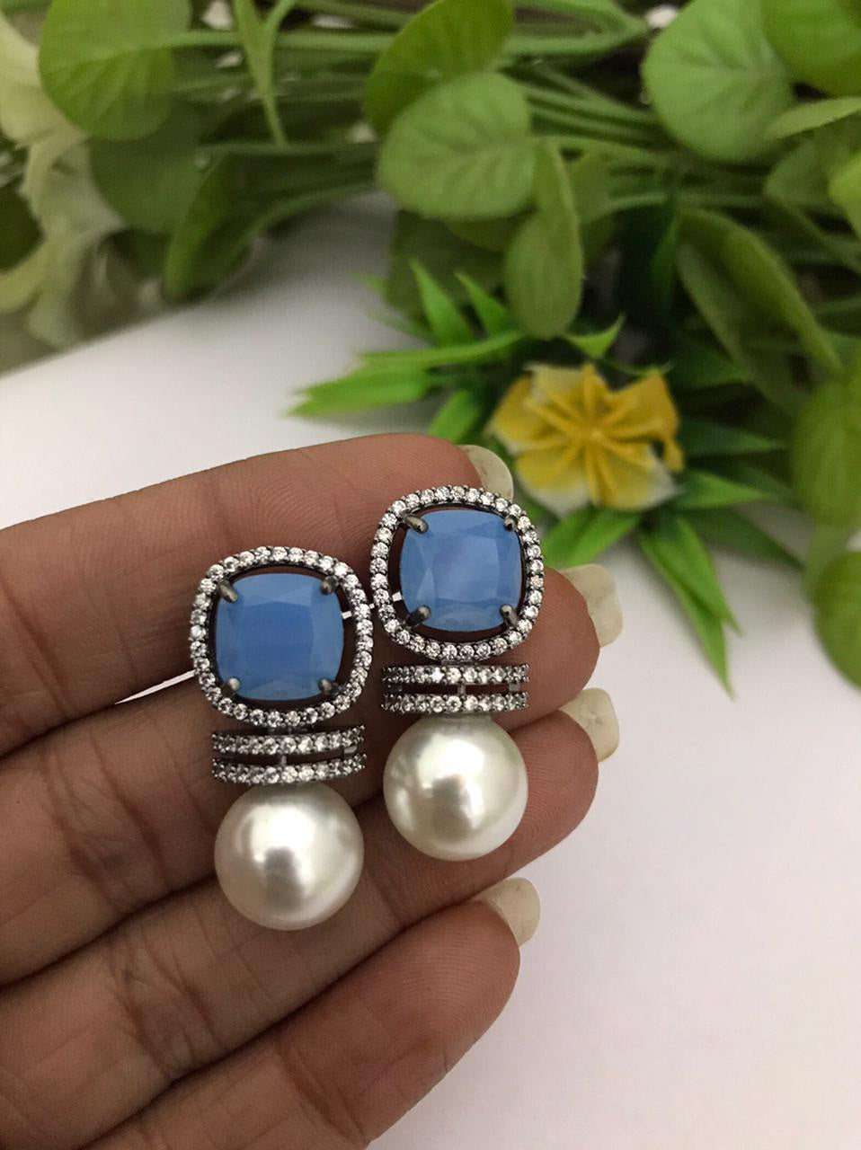 Buy Blue Stone Oval Shaped Stud Earrings by Noor Online at Aza Fashions.