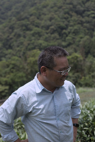 wild tea farmer standing in farm in Taiwan