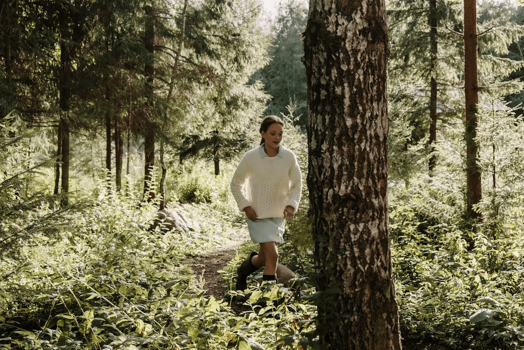 Person running on trail in the woods
