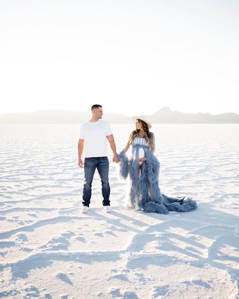 Maternity couple holding hands at the Salt flats