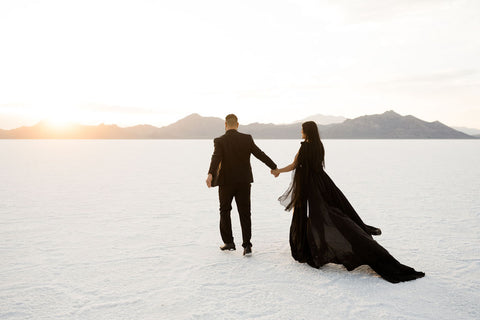 engagement couple at the salt flats in a black dress and suit