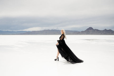 women standing on the salt flats in a flowing black dress