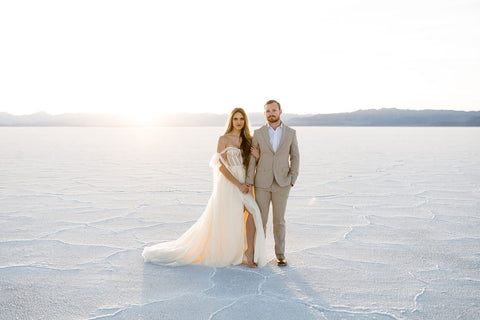 couple standing together embracing wearing formal attire in Salt Flats engagement session